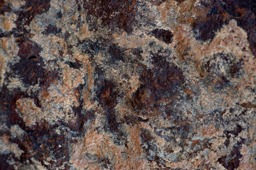 The texture of the stone with multi-colored spots. Textural background in the form of a stone with gray, black, yellow spots. Design on a stone background.