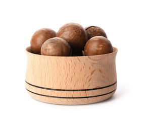 Bowl with organic Macadamia nuts on white background