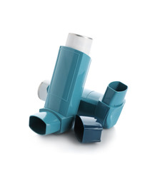 Two portable asthma inhalers on white background