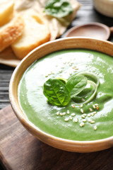 Fresh vegetable detox soup made of spinach in dish on table, closeup