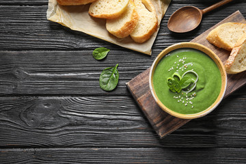 Fresh vegetable detox soup made of spinach served on table, top view. Space for text