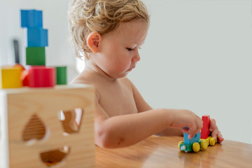 little girl playing colorful cubes on table