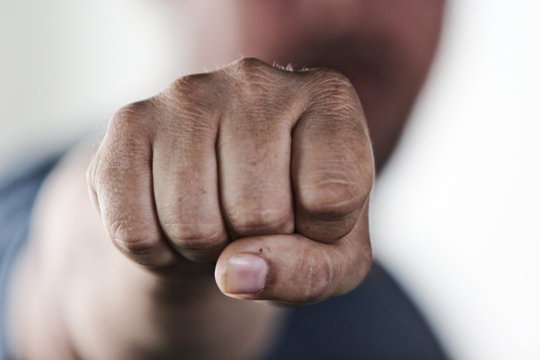 Aggressive man punching with fist