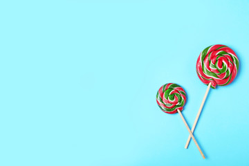 Tasty candies and space for text on color background, top view