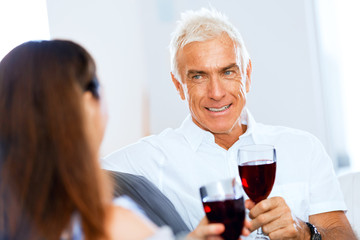 Portrait of a couple having a glass of red wine