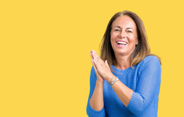 Middle age beautiful woman wearing winter sweater over isolated background Clapping and applauding happy and joyful, smiling proud hands together