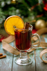 Mulled wine on old wooden background