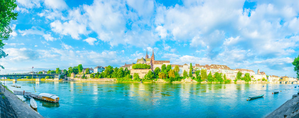 Riverside of Rhine in Basel dominated by majestic building of Munster church, Switzerland