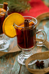 Mulled wine on old wooden background