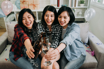 house party girls joyfully clinking champagne