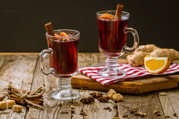 Mulled wine on old wooden background