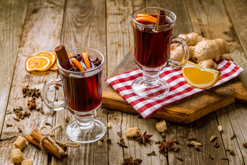 Mulled wine on old wooden background