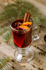 Mulled wine on old wooden background