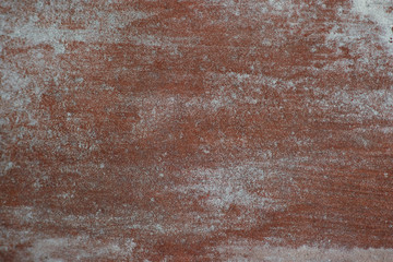 Texture of painted metal with strokes. The textural background of the metal is red-brown with white strokes of paint. Design on a metallic background.