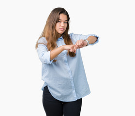 Fototapeta na wymiar Young beautiful brunette business woman over isolated background In hurry pointing to watch time, impatience, upset and angry for deadline delay