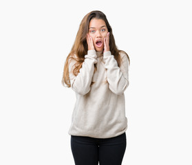 Young beautiful brunette woman wearing turtleneck sweater over isolated background afraid and shocked with surprise expression, fear and excited face.