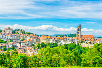 Tower of the cathedral of Saint Nicholas standing over skyline of Fribourg, Switzerland