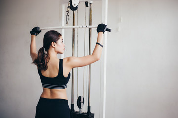 beautiful muscular fit woman exercising building muscles and fitness woman doing exercises in the gym. Fitness - concept of healthy lifestyle