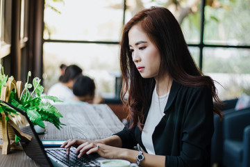 Asian business women using notebook for working
