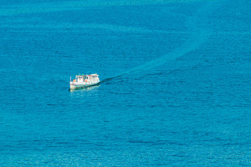 Passenger ferry is arriving to the pier at port at Lugano, Switzerland