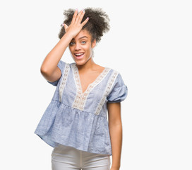 Young afro american woman over isolated background surprised with hand on head for mistake,...