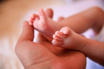 Father holding baby feet