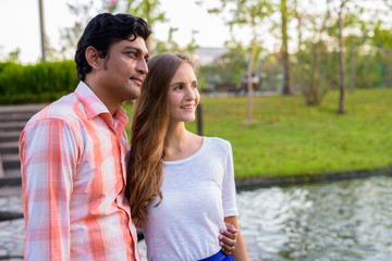 Fototapeta premium Happy multi ethnic couple smiling while thinking on stone path i