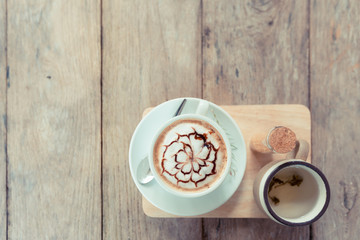 latte art coffe on wood table