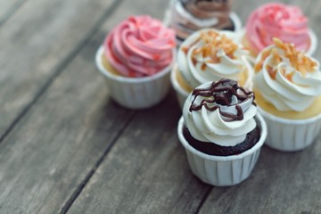 Group of cupcakes on wooden table background