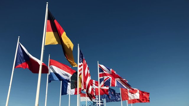 National Flags blowing in slow motion on blue sky