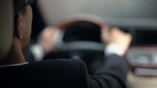 Businessman in suit waiting in car, traffic jam on road, being late for meeting