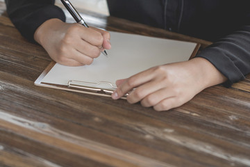 Close up of Hand holding pen, it's like a letter writer. Creative idea of work 2019 goals, writing, drawing,making notes in document.Business,investment,concept,Vintage ,Retro natural mood style.
