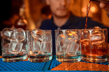  bartender prepares a  cocktail in the nightclub.