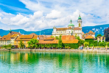Riverside of Aare passing through Solothurn is dominated by Saint Ursus Cathedral, Switzerland