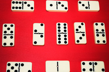 White domino on red background.