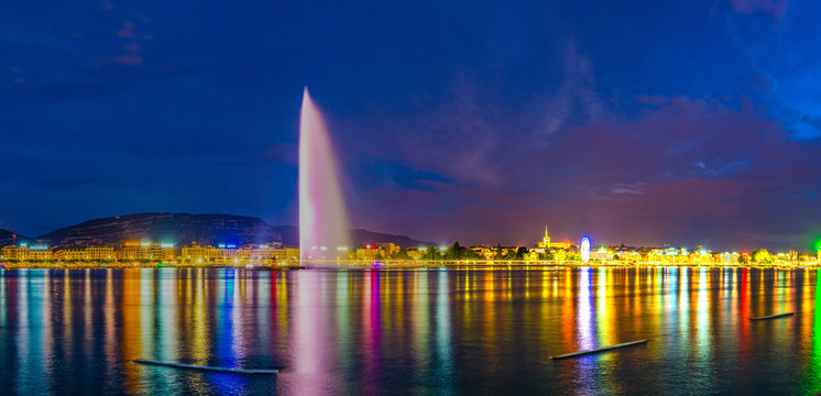Sunset view of Geneva dominated by Jet d'eau fountain and Saint Pierre Cathedral, Switzerland