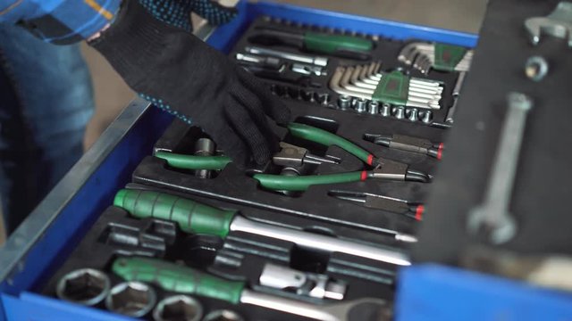 Close-up picture of mechanical workshop tools. Professional car mechanic using different tools for working in auto repair service.