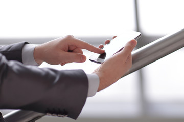 close up. businessman typing SMS on smartphone