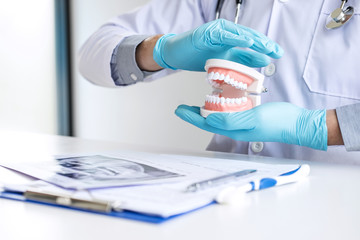 Doctor dentist protection dental tooth model on workplace with x-ray film