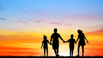 silhouette  happy family on the beach at  sunrise time