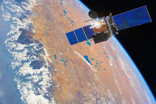 Fototapeta Low-orbit communication satellite in space above the Earth. Elements of this image furnished by NASA.
