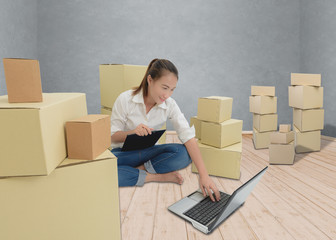 teenager owner business woman work at home with Clipboard, laptop for online shopping writing the order