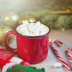 Obraz na płótnie Canvas Christmas. Christmas background. Happy New Year. Holiday Red mug with hot chocolate white marshmallows and candy in the shape of a Christmas tree. Selective focus.