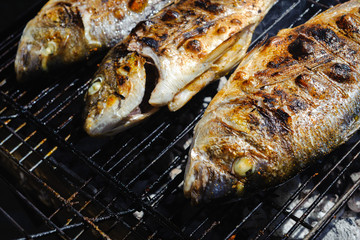 Fresh sea fish - dorado - cooked on charcoal