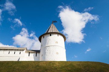 View of white tower on the hill and blue sky with white clouds background