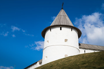 View of white tower on the hill and blue sky with white clouds background
