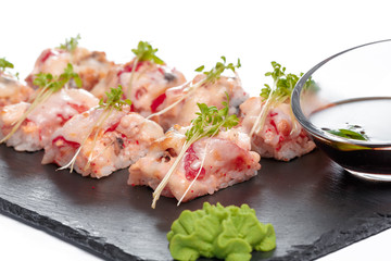 Black rectangle plate with sushi, isolated on white