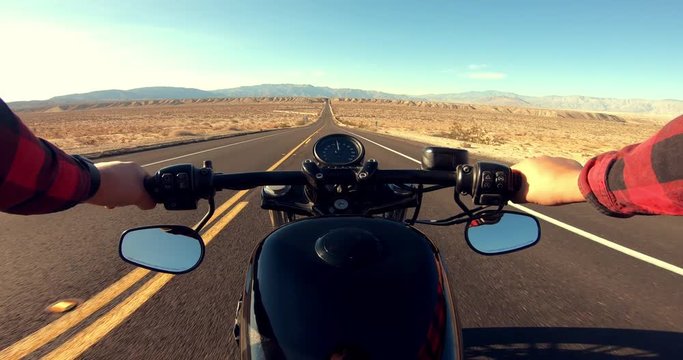 POV Point Of View Of Man Riding Motorcycle Down Straight Desert Road