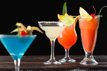 Alcoholic and non alcoholic cocktails on wooden table. Summer cold drinks