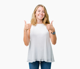 Fototapeta na wymiar Beautiful young elegant woman over isolated background success sign doing positive gesture with hand, thumbs up smiling and happy. Looking at the camera with cheerful expression, winner gesture.